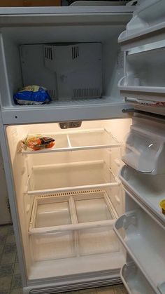 an open refrigerator with the door wide open and food in it's left drawer