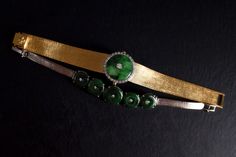 "Fine watch bracelet set with a jade donut and accented with diamonds in 18k. The donut is a deep green Omphacite jade, in parts dark and light like a globe lit. This jewel borrows the perfect finish of a Vacheron watch, its Omega straps in original burnished solid gold. More than a conversion piece, this bracelet could not have been refined to a sleeker layout. At 2cm, the donut is considered big yet its size is offset by the straps, and vice versa. The straps though wide feel made for its cent Timeless Green Jewelry For Evening, Timeless Green Evening Jewelry, Luxury Jade Bracelets For Formal Occasions, Luxury Formal Jade Bracelets, Fine Jade Jewelry For Formal Occasions, Luxury Jade Jewelry, Polished Green Jewelry For Evening, Green Polished Jewelry For Evening, Green Polished Evening Jewelry