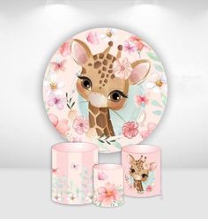 a giraffe with flowers on it is next to two cups and a plate