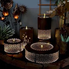 a group of decorative lights sitting on top of a table next to potted plants