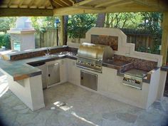 an outdoor kitchen with stainless steel appliances