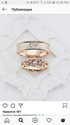 three gold rings with initials on them sitting next to each other in front of a white background