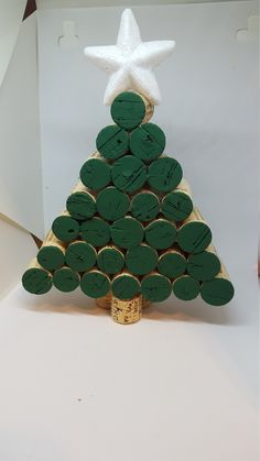 a christmas tree made out of wine corks with a white star on the top