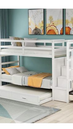 a white bunk bed sitting next to a window in a room with blue walls and wooden floors