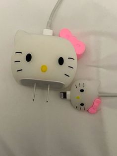 two hello kitty headphones are plugged into the wall