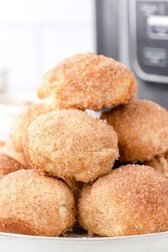 some sugary donuts stacked on top of each other in front of an instant pressure cooker