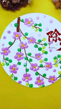 a paper plate with flowers painted on it