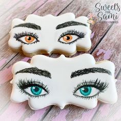 two decorated cookies with eyes and lashes on them