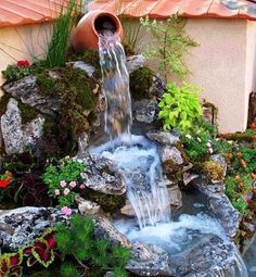 a small waterfall in the middle of a garden