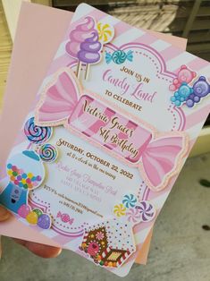 a person holding up a birthday card with candy land on the front and back side