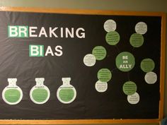 a bulletin board with green and white circles on it that says breaking bias be an ally