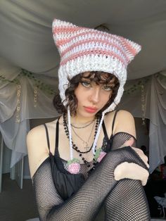 a woman wearing fishnet stockings and a knitted hat