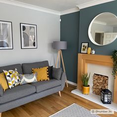 a living room filled with furniture and a fire place in front of a wall mounted mirror