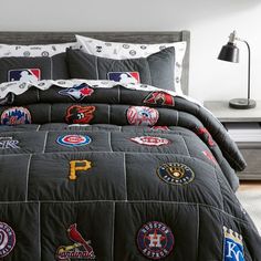 a baseball themed comforter set with many different patches on the cover and pillow cases