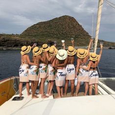 a group of people standing on top of a boat