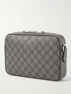 Gucci updates its vintage-inspired 'Ophidia' messenger bag in versatile shades of grey. Made in Switzerland from coated-canvas that's patterned with the label's 'GG' monogram, it has a compact rectangular shape and an adjustable strap you can wear crossbody. The silver-tone hardware matches the designer emblem at the front. Luxury Gray Shoulder Bag With Dust Bag, Luxury Gray Shoulder Bag, Modern Gucci Shoulder Bag In Monogram Canvas, Modern Gucci Monogram Canvas Shoulder Bag, Gray Business Bags With Silver-tone Hardware, Designer Gray Shoulder Bag For Travel, Luxury Gray Bag With Palladium Hardware, Luxury Gray Bag With Removable Pouch, Designer Gray Rectangular Shoulder Bag