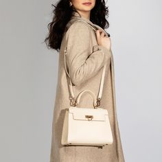 Layla Cream Top Handle & Crossbody Bag: Introducing Levantine 's newest addition: the cream top handle bag. Designed for the modern woman, this bag combines classic charm with contemporary flair. Its sleek silhouette and neutral shade make it a versatile accessory for any occasion. Whether you're running errands or attending a formal event, this bag is the perfect companion. Crafted with meticulous attention to detail, it exudes luxury and refinement. Elevate your look with Levantine's cream top handle bag. Bag Specifications Material: Vegan leather Interior: Luxurious suede lining Handles: Single handle, Removable shoulder strap Hardware: Golden-tone metal flap Pockets: One inner zipped pocket Closure: Front flap closure Size and Fit- Height: 20 cms / 7.9 In Handle Height: 10 cm / 3.9 In Laptop Handbags, Sling Bag Women, Laptop Handbag, Work And Travel, Cream Top, Cream Tops, Top Handle Bags, Women Bags Fashion, The Cream