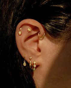 a woman with three ear piercings on her ears