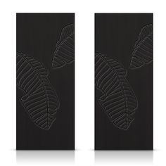 the back side of a pair of black door panels with leaves on them, against a white background