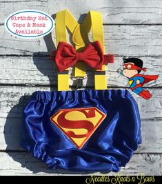 a blue superman diaper with a red bow on it and a yellow suspender