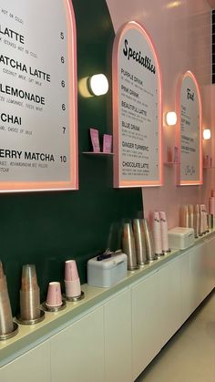 there are many different items on the counter in this restaurant that is pink and green