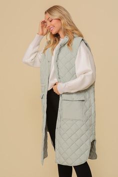 A trendy and chic sleeveless midi windbreaker, featuring a quilted design and a cute hood for the rainy days. Vest has snap-on buttons and front pockets. Fabric Contents: 100% Polyester Care Instructions: Machine wash cold, gentle cycle, tumble dry low. Size Measurement (inch): S: 22.5 (Bust), null (Waist), null (Hips), 39.0 (Length) M: 23.0 (Bust), null (Waist), null (Hips), 39.5 (Length) L: 23.5 (Bust), null (Waist), null (Hips), 40.0 (Length) Long Sleeveless Vest, Oversized Vest, Hooded Vest, Saint John, Gameday Outfit, Vest Fashion, Sleeveless Vest, China Fashion, Puffer Vest