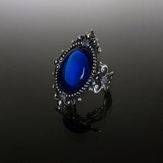 This ornate ring features a Sapphire blue cabochon set in a beautifully decorative mount (measuring 35 x 25 mm) on a stunning filigree band. The Sterling silver plated filigree ring is adjustable so one size fits all. The deep Sapphire blue cabochon shimmers beautifully when it catches the light. Nickel and lead free. This Sapphire blue filigree ring compliments perfectly our Sinistra lace choker which can be found in our Etsy store. The full Sinistra range of venise lace chokers and matching ri Luxury Victorian Sapphire Ring For Gift, Luxury Victorian Sapphire Ring, Luxury Victorian Style Sapphire Ring, Luxury Bohemian Blue Ring, Luxury Victorian Sapphire Ring Collectible, Luxury Victorian Sapphire Ring As Gift, Black And Dark Blue Rings, Luxury Ornate Rings For Formal Events, Luxury Blue Sapphire Victorian Ring