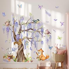 a child's room with a tree and animals on the wall next to it