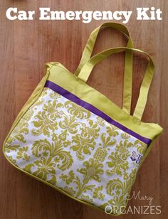 a yellow and white bag sitting on top of a wooden floor with the words car emergency kit