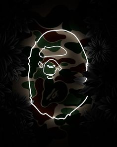 a man's head in the middle of a dark background with leaves on it