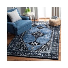 a blue area rug with black and white designs on the bottom in front of a chair