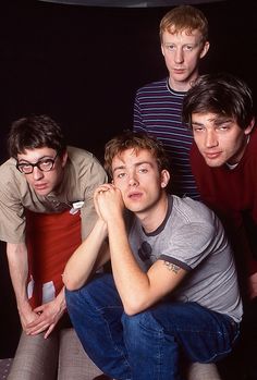 four young men are posing for the camera