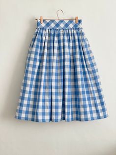 "Denim Blue check high waist full gathered skirt. Perfect for casual outfits and special ocasions with pair of trainters or high heels. 100% cotton.  Elastic at the back of waist.  Two side pockets. Midi lenght about 70cm + 5 cm waistband. Handmade in UK.  Model wears size S.  HOW TO CHOOSE A SIZE ?   Using a measuring tape, measure the smallest part of your waist.  SIZE CHART: (CM) XS - W: 66 CM S - W: 70 CM M - W: 74 CM  L - W: 78 CM  XL - W: 82 CM  CARE INSTRUCTIONS: Hand wash only, do not bleach, hang dry, do not tumble dry, press with a cool iron on the reverse side.  Please message me before purchasing so I can check availability. If you wish this skirt in any other fabric, shorter or longer \"send message to seller\" and we can try to make something especially for you. *Depends on c Casual Gingham Gathered Skirt, Gingham Gathered Skirt Bottoms For Spring, Spring Gingham Gathered Skirt Bottoms, Gingham Gathered Skirt For Spring, Fitted Cotton Skirt For Picnic, Spring Gingham Gathered Skirt, Plaid Cotton Relaxed Skirt, Plaid Cotton Lined Skirt Bottoms, Gingham Pleated Skirt Bottoms For Summer