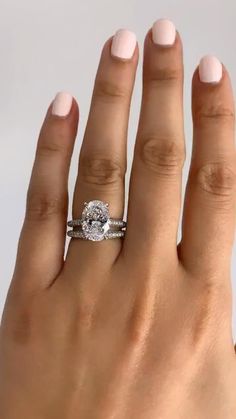 a woman's hand with a diamond ring on it