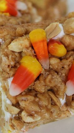 a close up of a piece of food with candy cornflakes and nuts on it