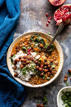 a bowl filled with beans and rice next to a pomegranate