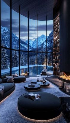 a living room filled with furniture and a fire place in the middle of a floor to ceiling window