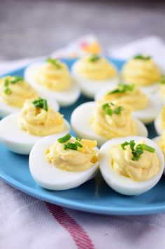 deviled eggs with chives on a blue plate