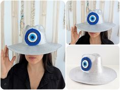 a woman wearing a silver hat with an evil eye on the front and blue eyes on the back