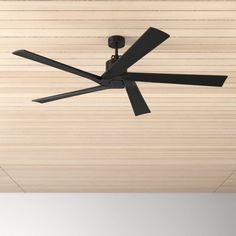 a ceiling fan mounted to the side of a wooden ceiling with black blades on it