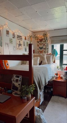 a bed room with a neatly made bed and lots of lights on the wall above it