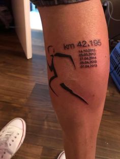 a person with a tattoo on their leg that reads km 429, and has an arrow