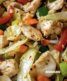 chicken stir fry with peppers, onions and carrots in a wok on the stove