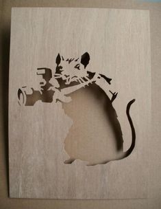 a cutout of a mouse on a piece of wood