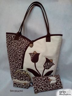 a white and brown bag with flowers on it next to two small purses,