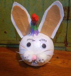 a paper mache bunny head on top of a wooden table