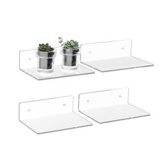 three glass shelves with plants in them on top of each other and one shelf holding two potted plants