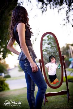 a woman standing in front of a mirror