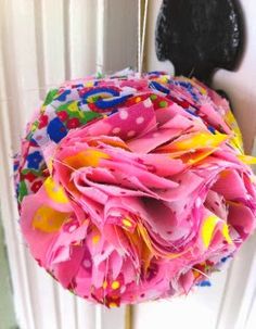 a close up of a flower on a stick in front of a window sill