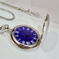 Pocket Watch, Silver Colour, Blue Dial, Snake Design Chain, Roman Numeral Dial, Groomsman Watch, Charismatic Design, Vintage Design, Cool Design Watch Diameters: Total Length: 43 cm (with chain) Case Diameter: 60mm (with Crown) x 47mm Case Thickness: 15mm Weight: 55gr (with Chain) Blue Stainless Steel Watch Accessory With Metal Dial, Classic Blue Watches For Gifts, Classic Blue Watch As Gift, Classic Blue Watches As A Gift, Blue Analog Watch Accessories As Gift, Blue Analog Watch As A Gift, Blue Analog Watch As Gift, Blue Analog Watch Gift, Gift Blue Analog Watch